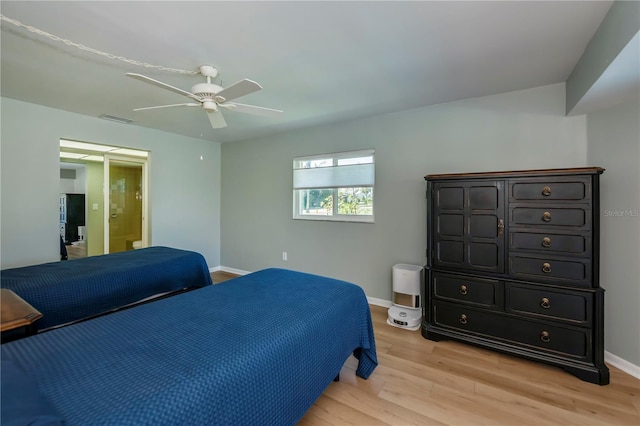 bedroom featuring ceiling fan, light hardwood / wood-style flooring, and ensuite bathroom