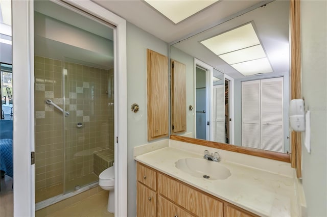 bathroom featuring an enclosed shower, vanity, and toilet