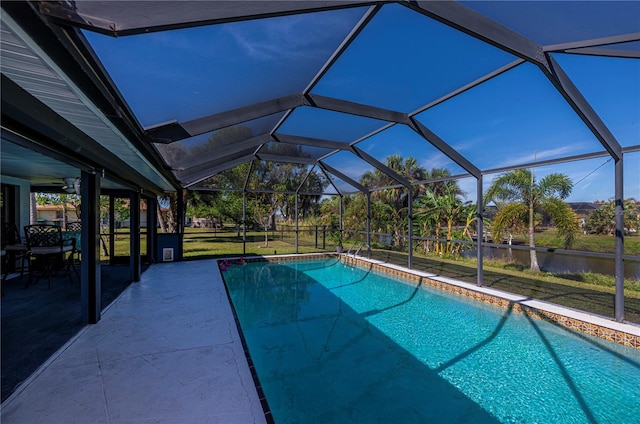 view of pool with glass enclosure and a patio area