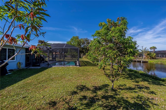 view of yard featuring a water view and glass enclosure