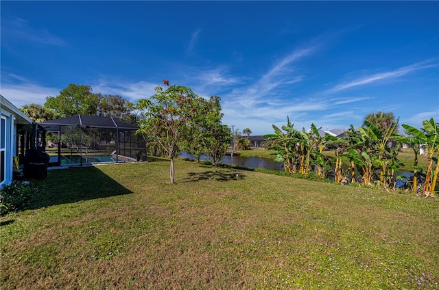 view of yard featuring a water view and a lanai