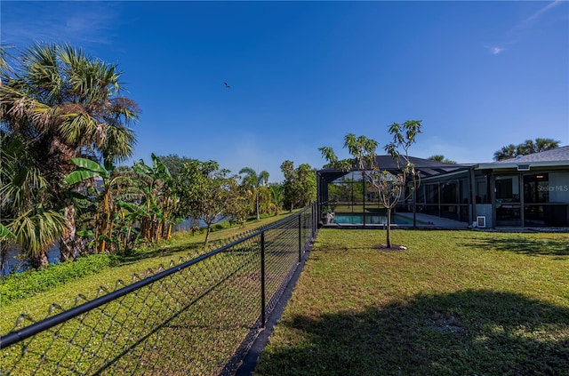 view of yard with a fenced in pool and glass enclosure