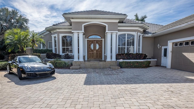 doorway to property with a garage