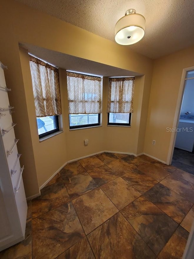 empty room with a textured ceiling