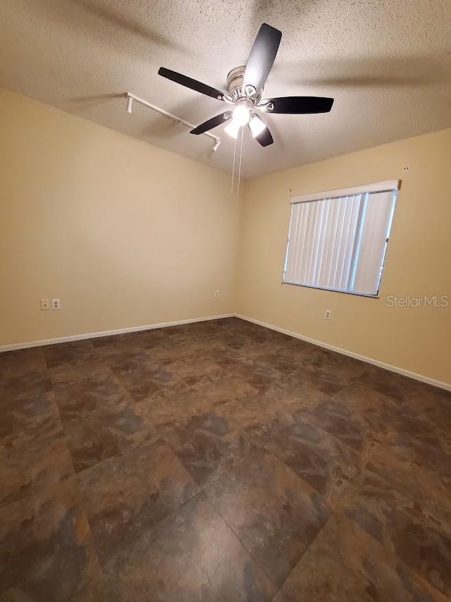 unfurnished room featuring a textured ceiling and ceiling fan