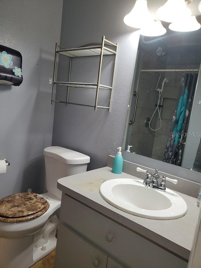 bathroom featuring vanity, toilet, and curtained shower