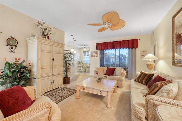 living room featuring ceiling fan and light colored carpet