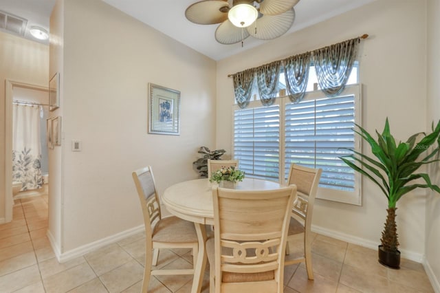 dining area with ceiling fan and light tile patterned flooring