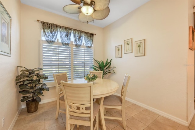 tiled dining space with ceiling fan