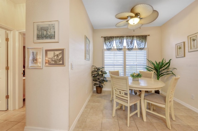 dining space with light tile patterned floors and ceiling fan