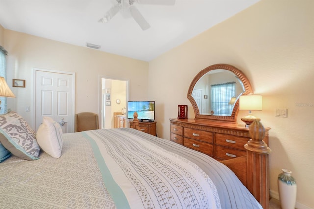 bedroom with ceiling fan, ensuite bathroom, and a closet