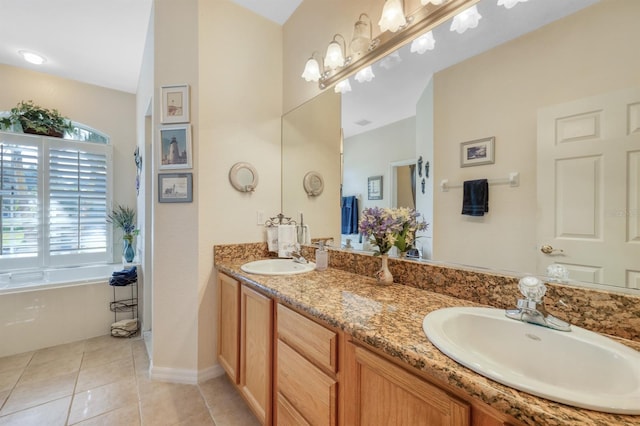 bathroom with vanity, tile patterned floors, and a bathtub