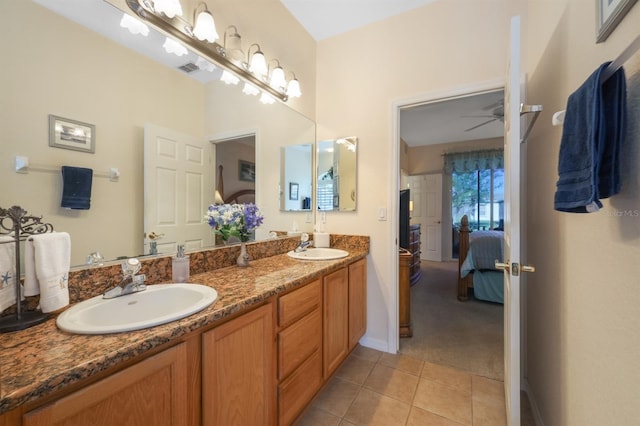 bathroom with tile patterned floors, vanity, and ceiling fan