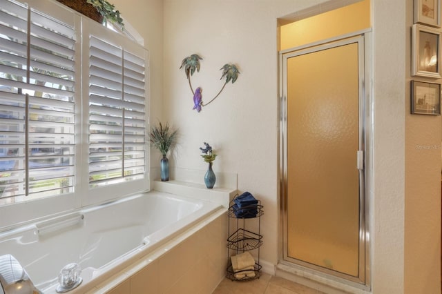 bathroom featuring tile patterned floors and separate shower and tub