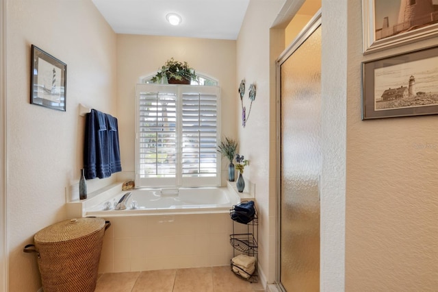 bathroom featuring tile patterned flooring and independent shower and bath