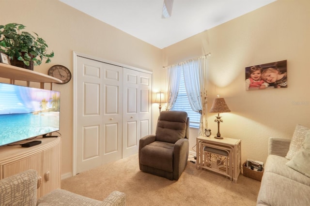 sitting room featuring light colored carpet