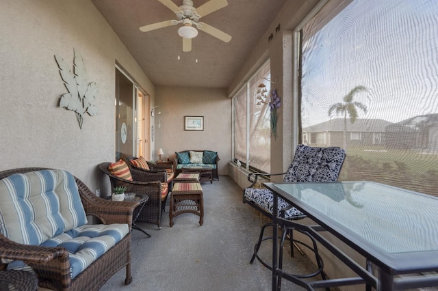 sunroom featuring ceiling fan