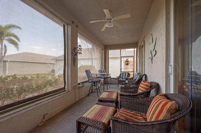 sunroom / solarium featuring ceiling fan