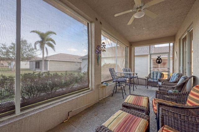 sunroom / solarium featuring ceiling fan