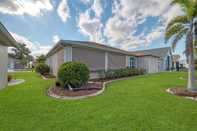 view of home's exterior with a lawn