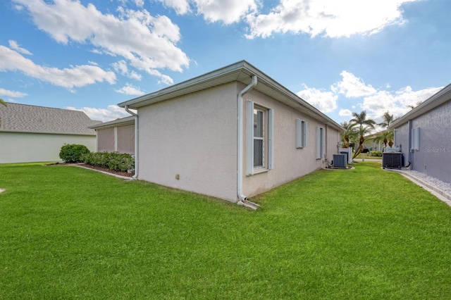 view of property exterior with central AC and a yard