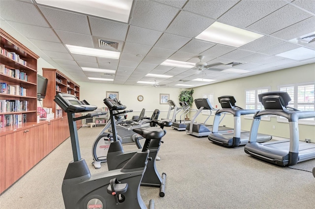 workout area featuring carpet, a paneled ceiling, and ceiling fan