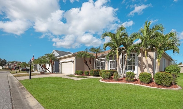 view of front of property with a garage and a front lawn