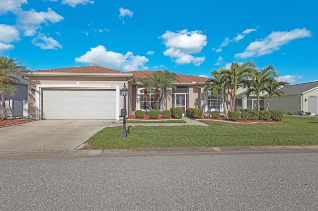 view of front of property with a front yard and a garage