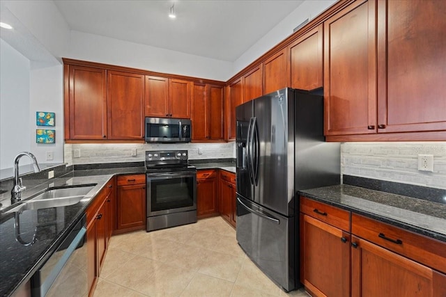 kitchen featuring backsplash, stainless steel appliances, dark stone counters, and sink