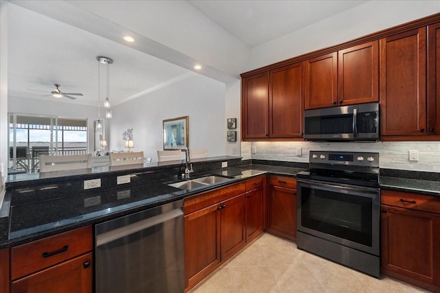 kitchen featuring decorative backsplash, appliances with stainless steel finishes, ceiling fan, sink, and dark stone countertops