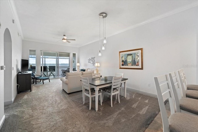 dining room with carpet flooring, ceiling fan, and ornamental molding