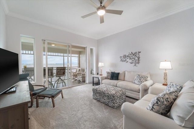 carpeted living room featuring ceiling fan and ornamental molding