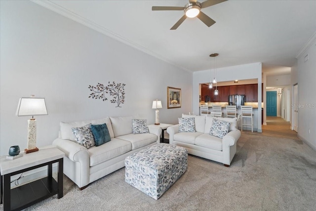 living room featuring light colored carpet, ceiling fan, and crown molding