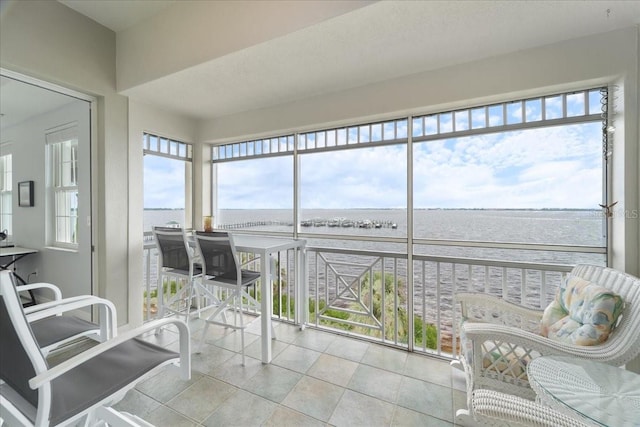 sunroom / solarium featuring a water view