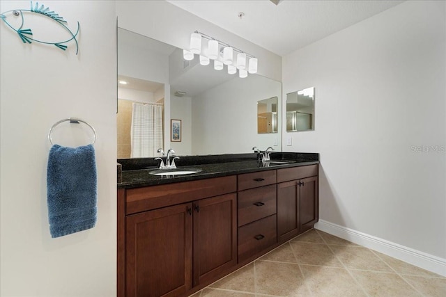 bathroom with tile patterned flooring, vanity, and curtained shower