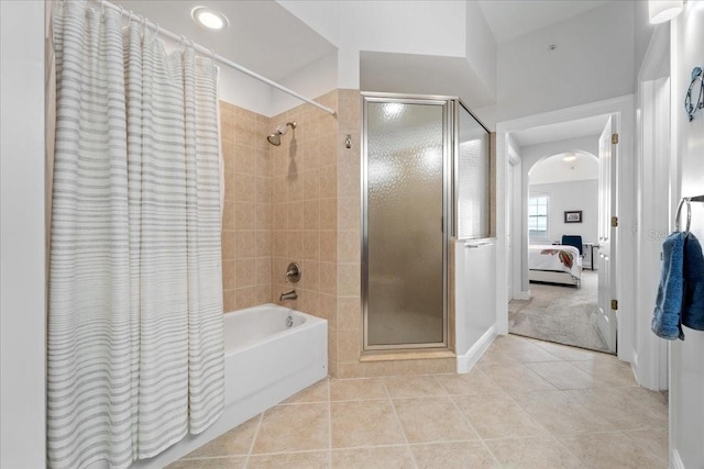 bathroom with tile patterned flooring and shower with separate bathtub