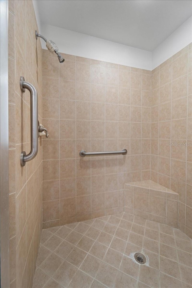 bathroom with tiled shower