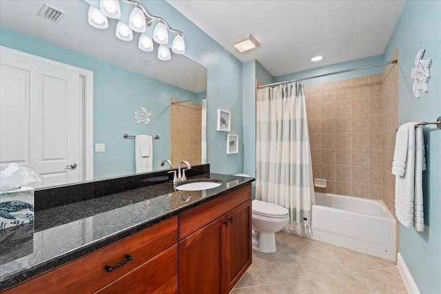 full bathroom with tile patterned floors, shower / tub combo with curtain, vanity, and toilet