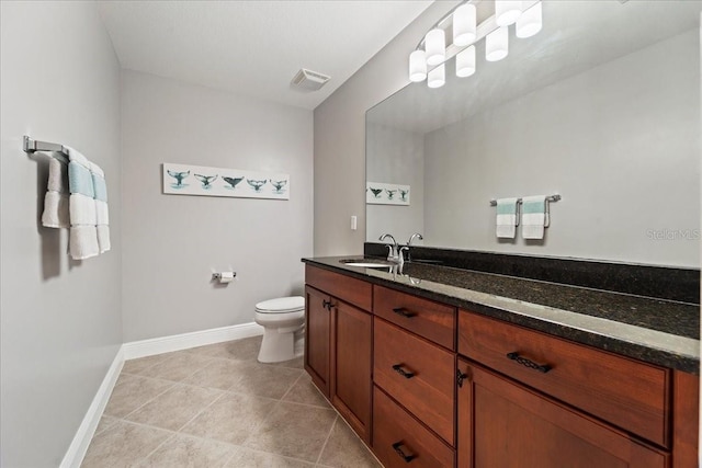 bathroom featuring tile patterned floors, vanity, and toilet