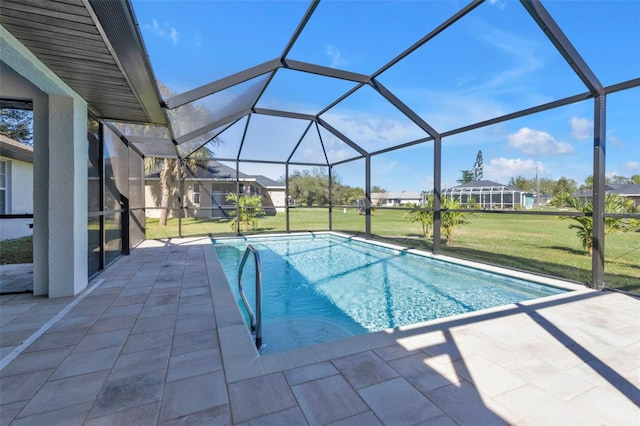 view of pool featuring a patio area, a lanai, and a lawn