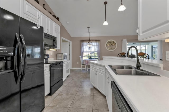 kitchen with a healthy amount of sunlight, white cabinets, black appliances, and lofted ceiling