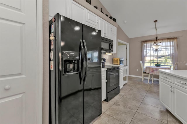 kitchen featuring vaulted ceiling, black appliances, light tile patterned floors, white cabinetry, and hanging light fixtures