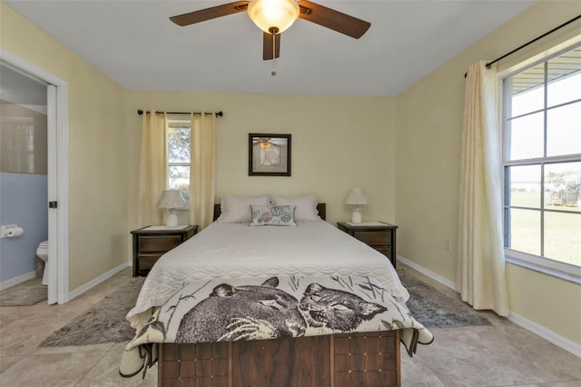 bedroom with ensuite bath and ceiling fan