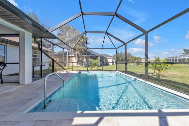 view of swimming pool featuring glass enclosure, a yard, and a patio