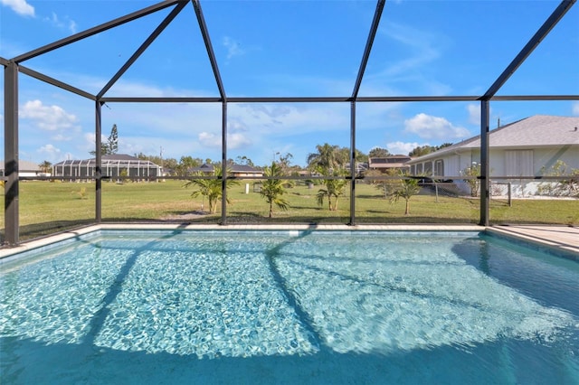 view of swimming pool with glass enclosure and a lawn