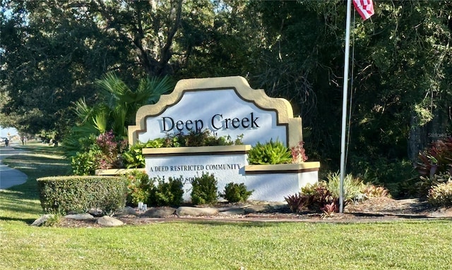 community / neighborhood sign with a lawn