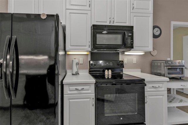 kitchen featuring a toaster, black appliances, white cabinets, and light countertops