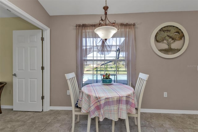 dining space featuring tile patterned flooring and baseboards