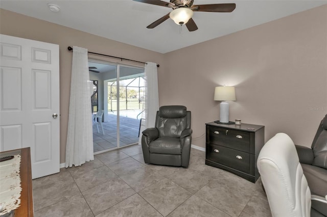 living area with light tile patterned floors, baseboards, and ceiling fan