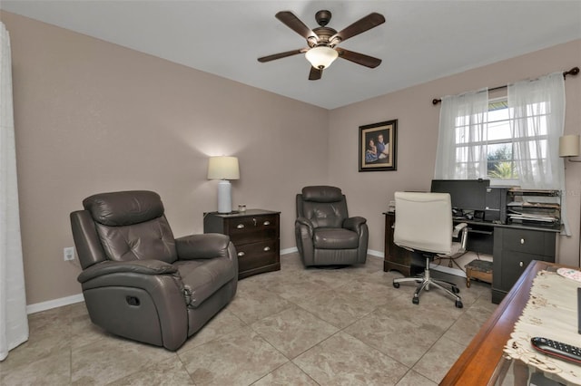 office with light tile patterned floors, a ceiling fan, and baseboards